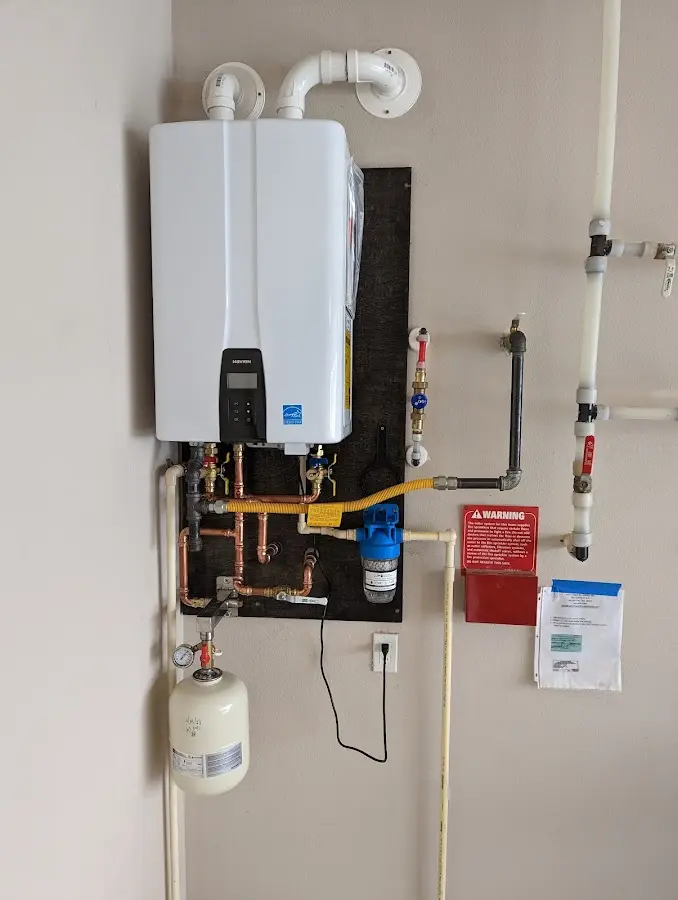 Professional plumber installing copper piping in a Parkersburg home